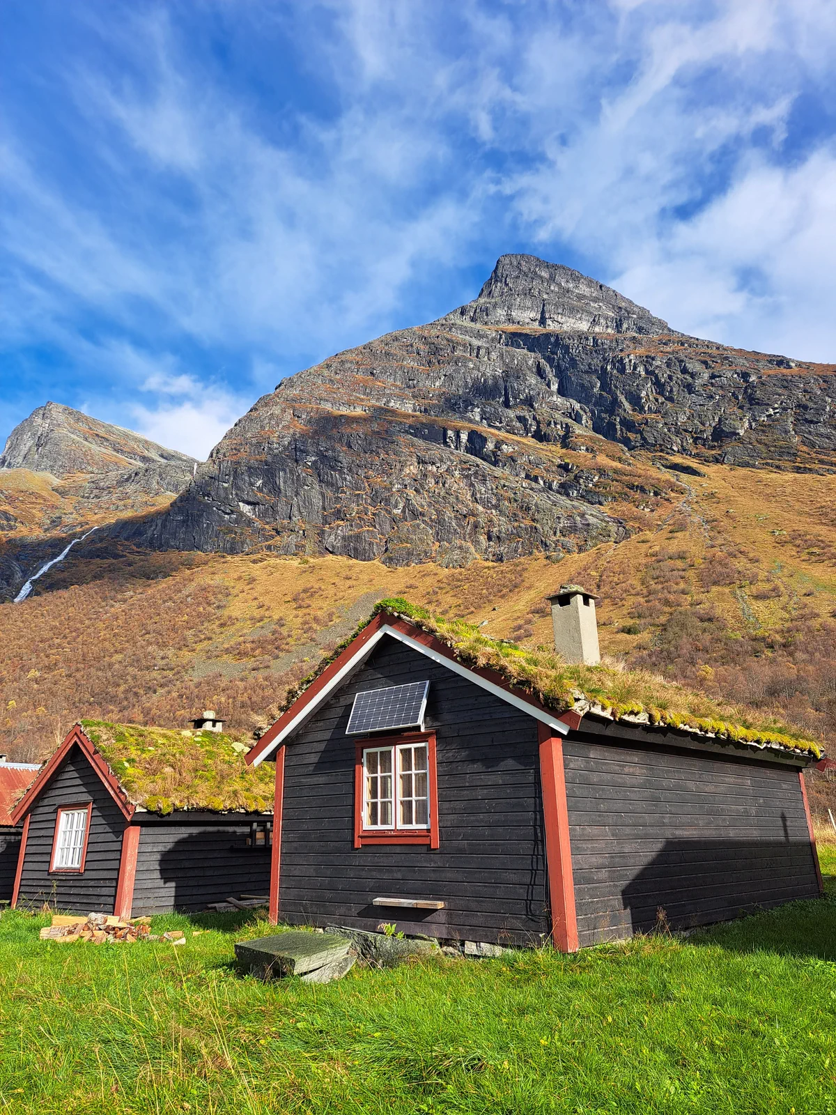Norwegian cabin with a turf roof in the valley