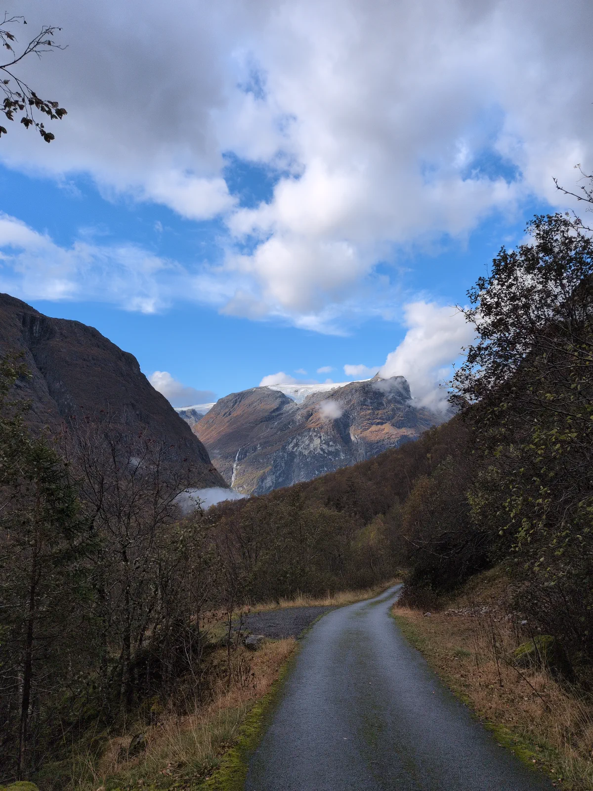 Paved road towards the Bødalen valley with mountains ahead