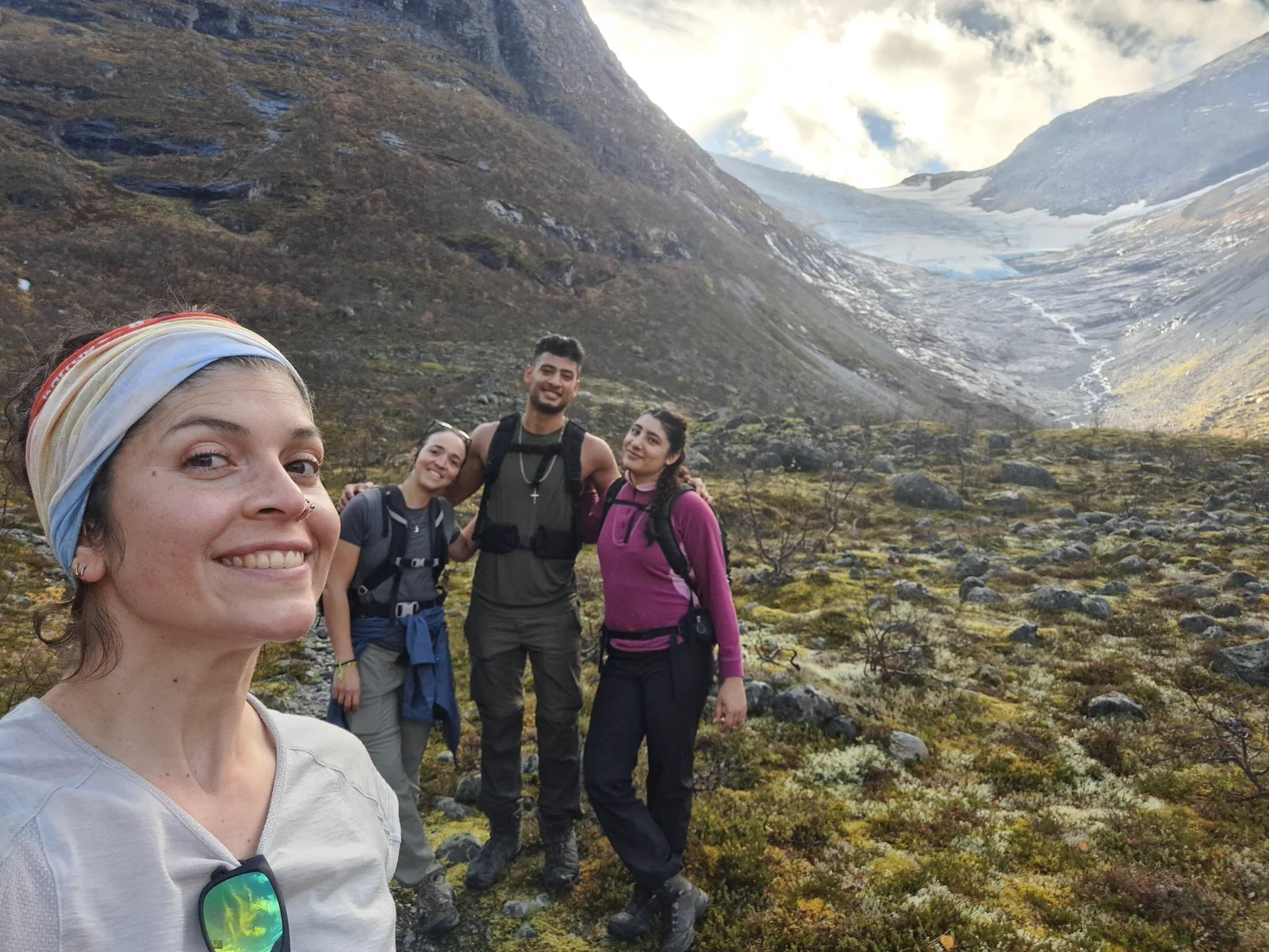 Four group members in front of the glacial landscape