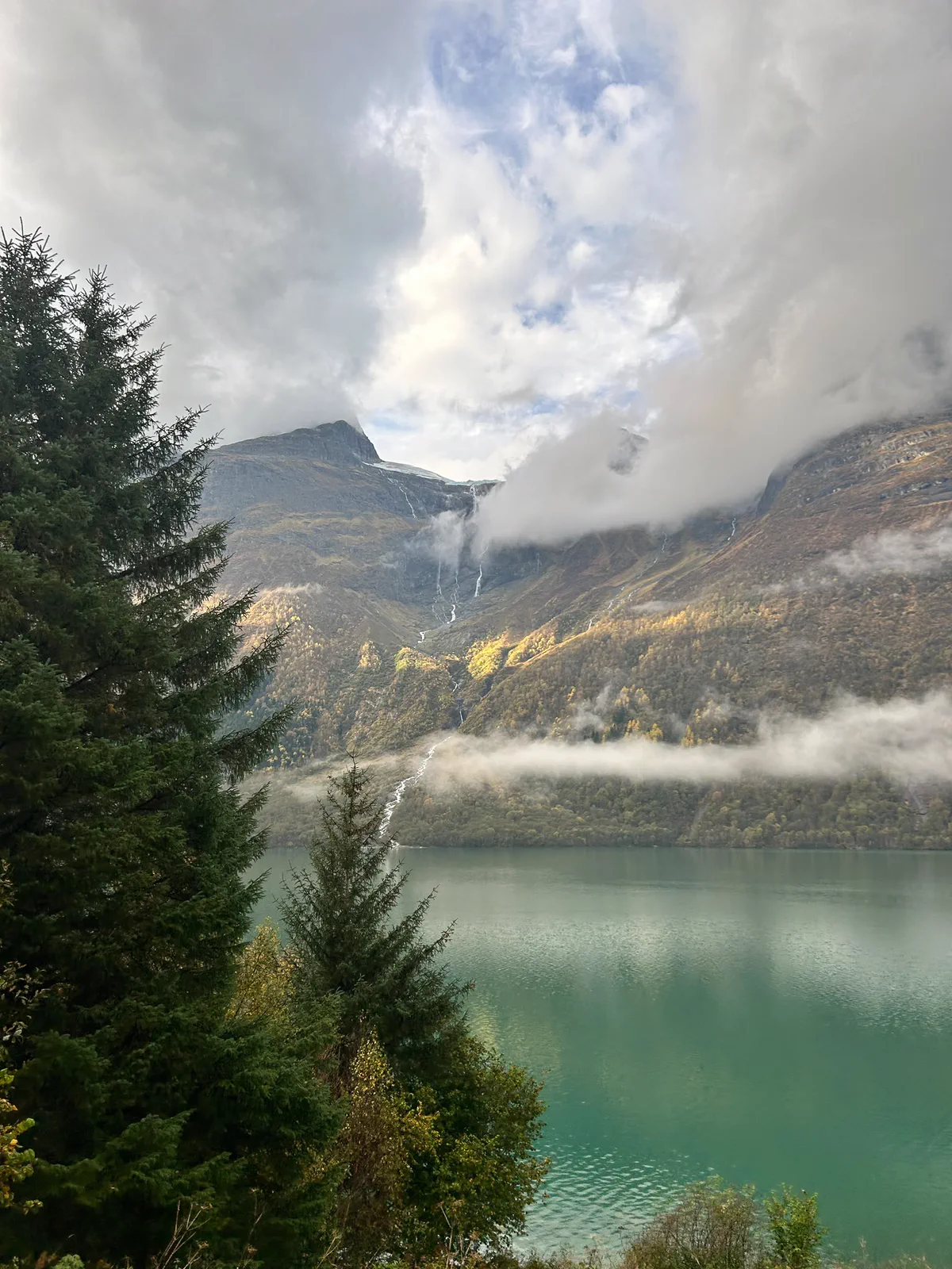 Mountains in low cloud beside the water