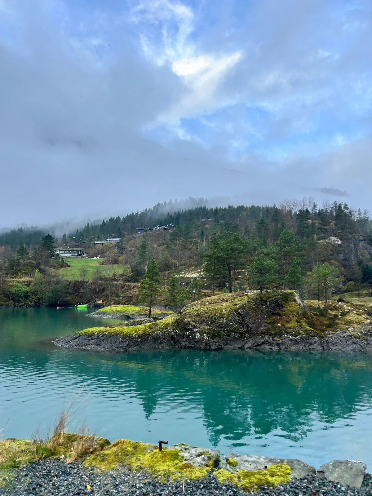 Turquoise waterline with trees and hills