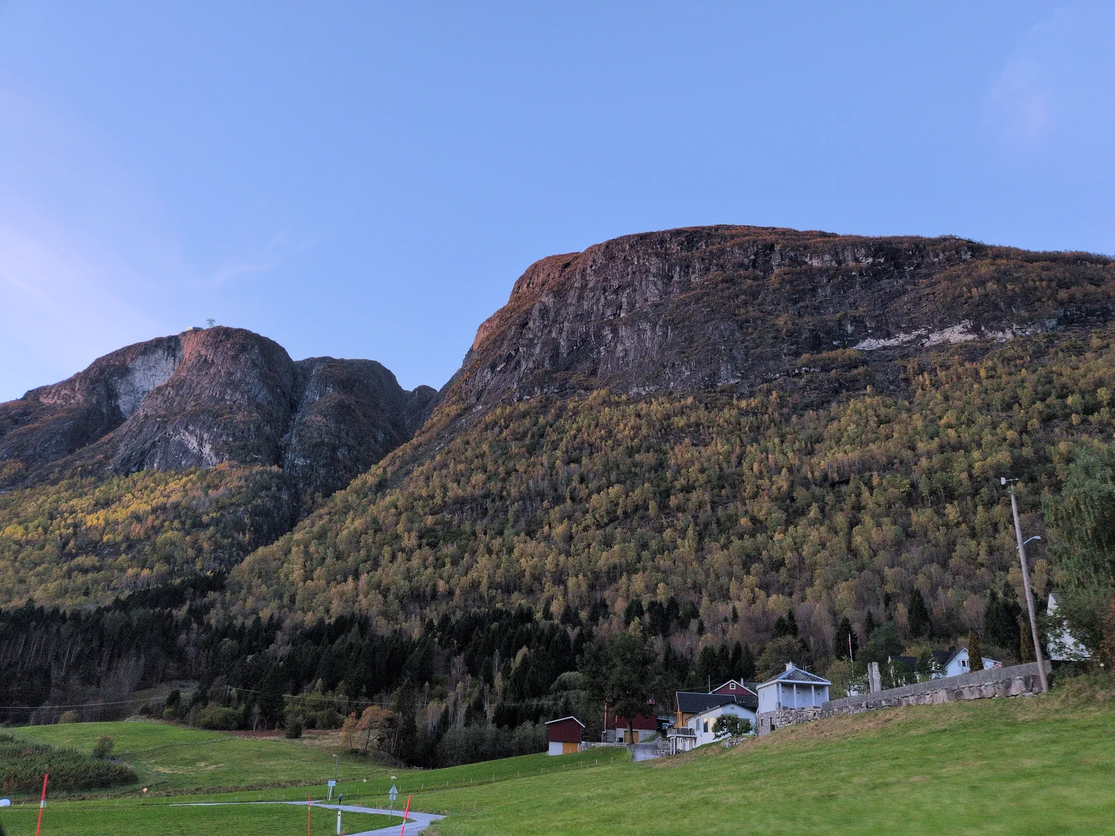 Open valley landscape with buildings below the hillside