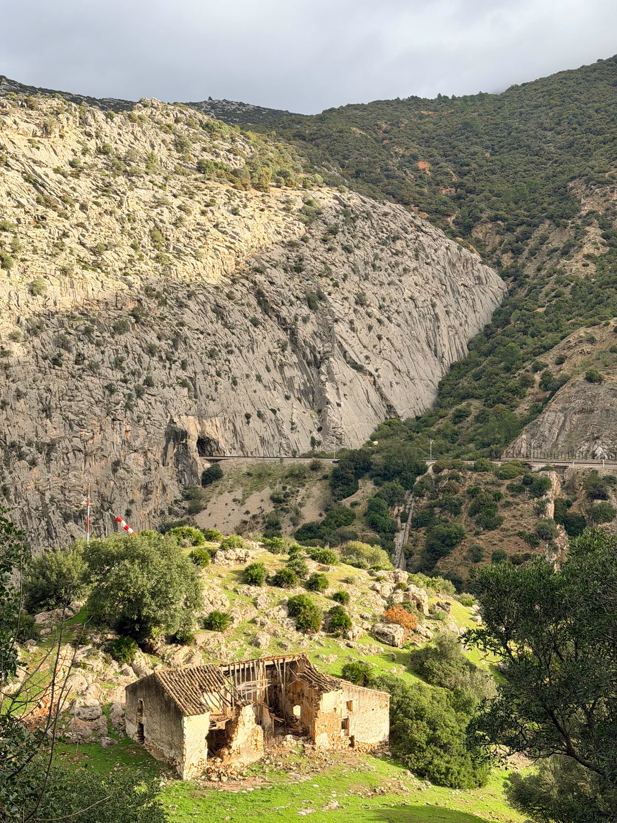 Rocky valley with an old building beside the route