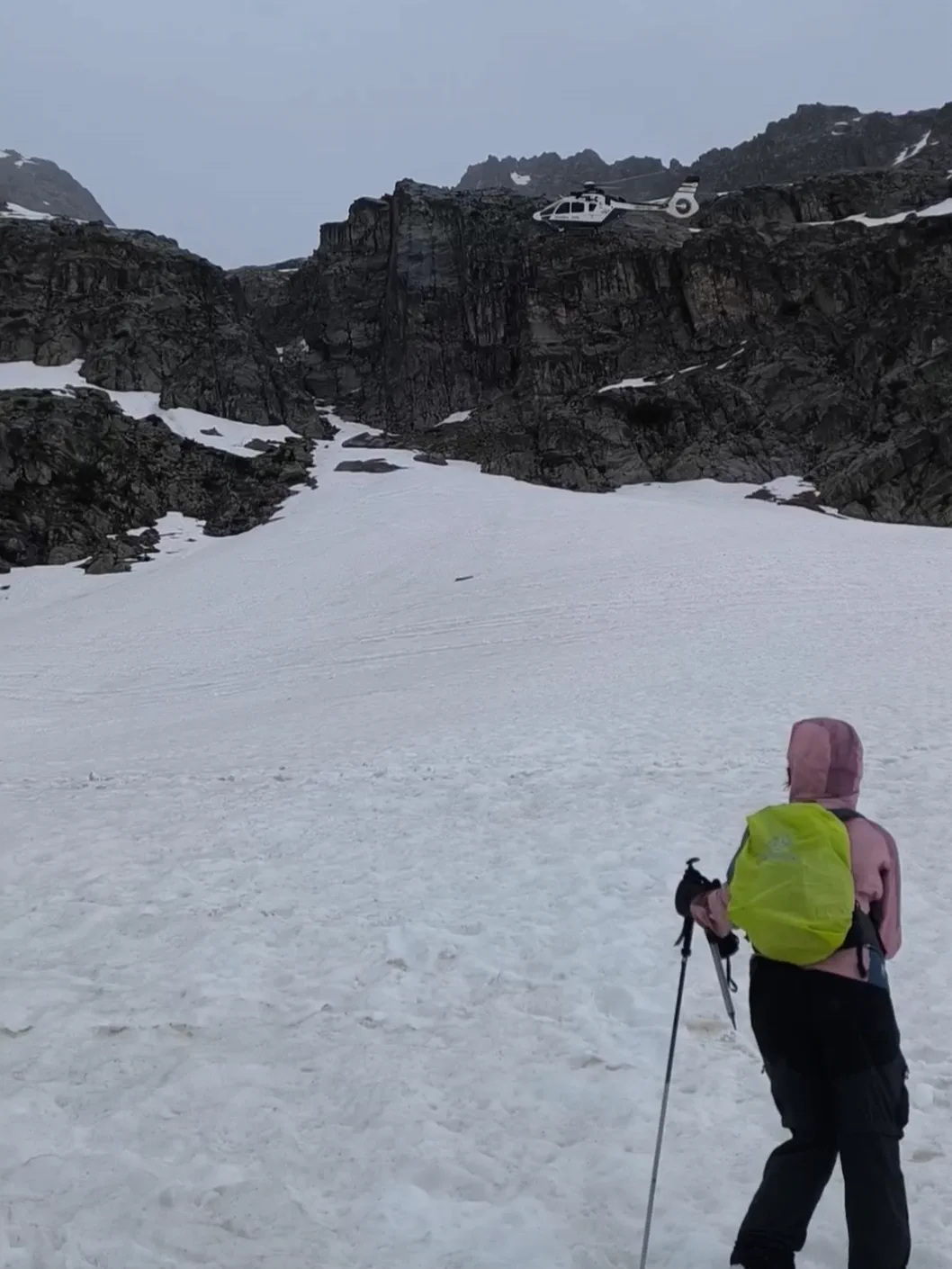 A mountaineer climbs a snowy couloir