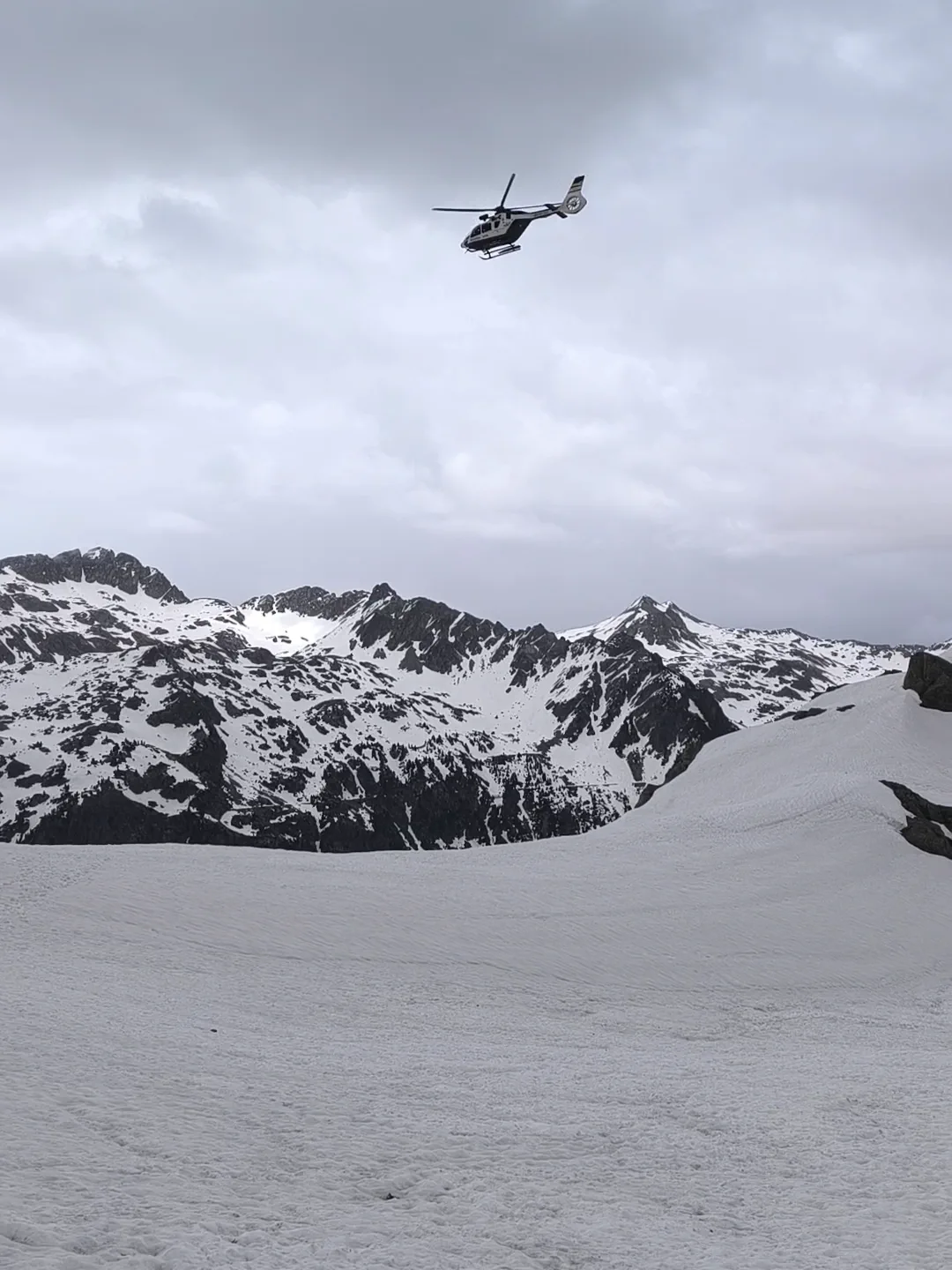 Rescue helicopter above the snowy valley