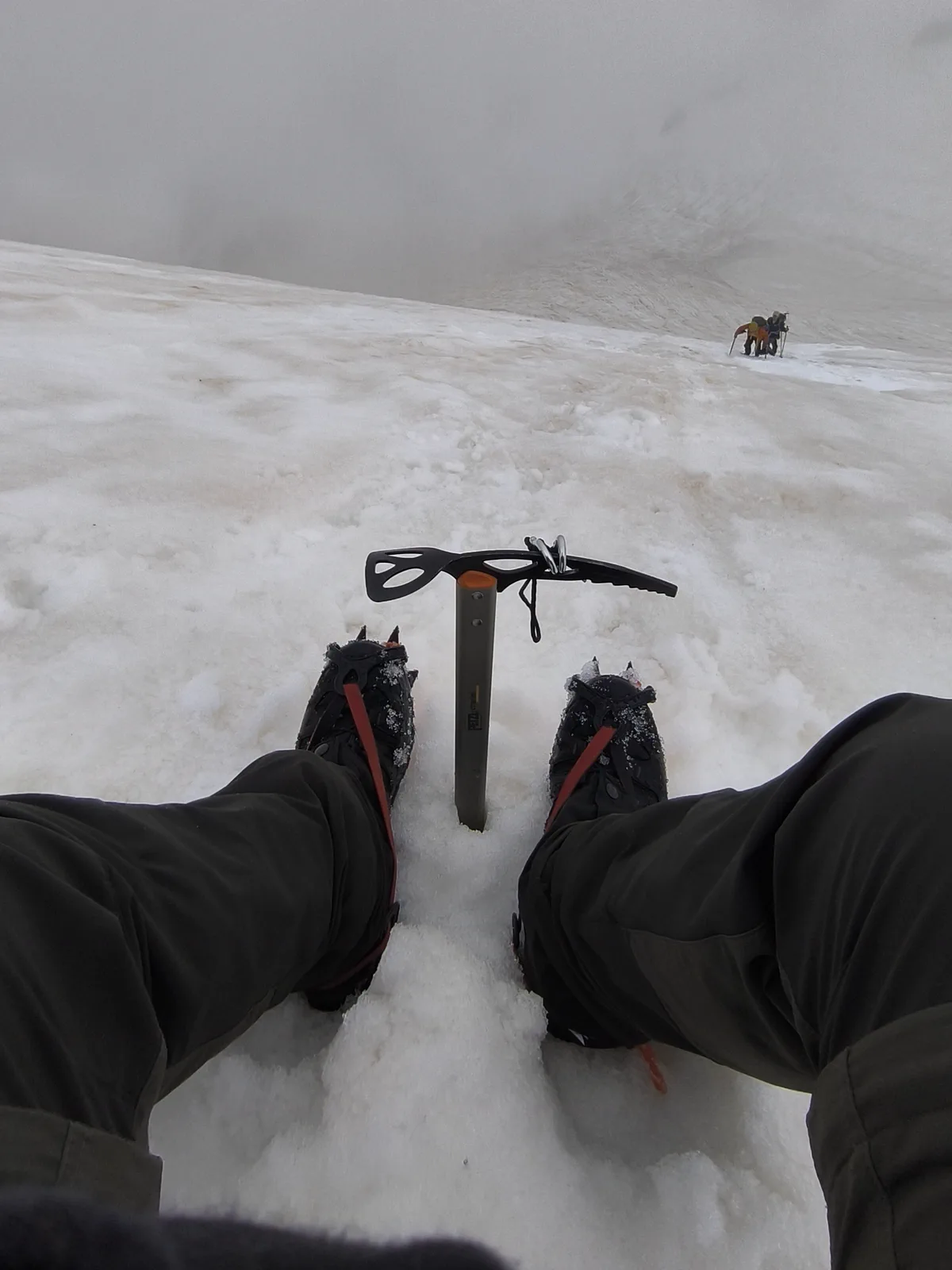 Crampons and an ice axe during a break on the snow