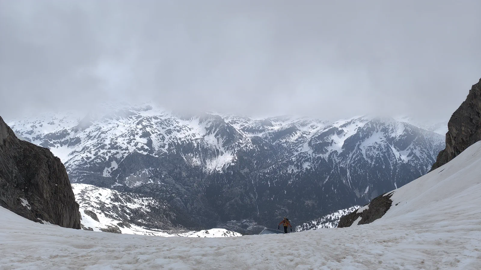 A mountaineer climbs a snowy couloir above the Tena Valley