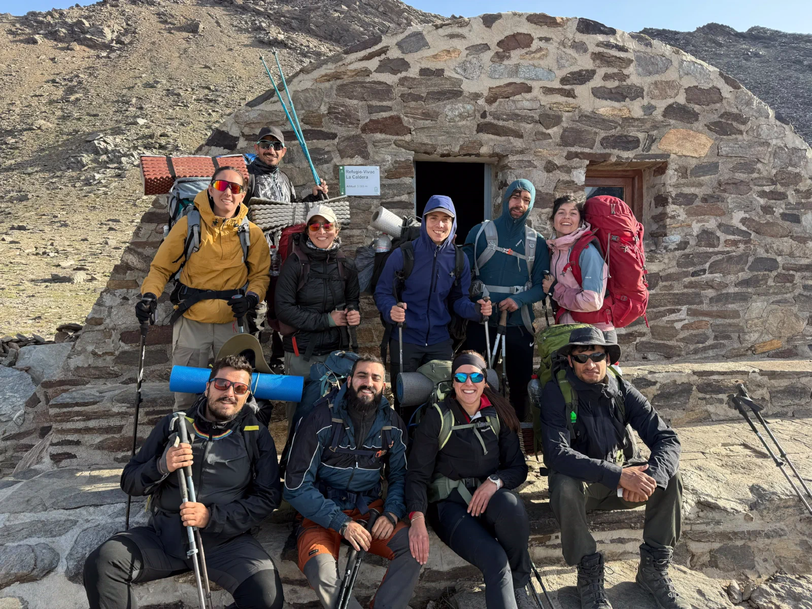 Mountain group in front of La Carihuela bivouac shelter during the Integral Sierra Nevada