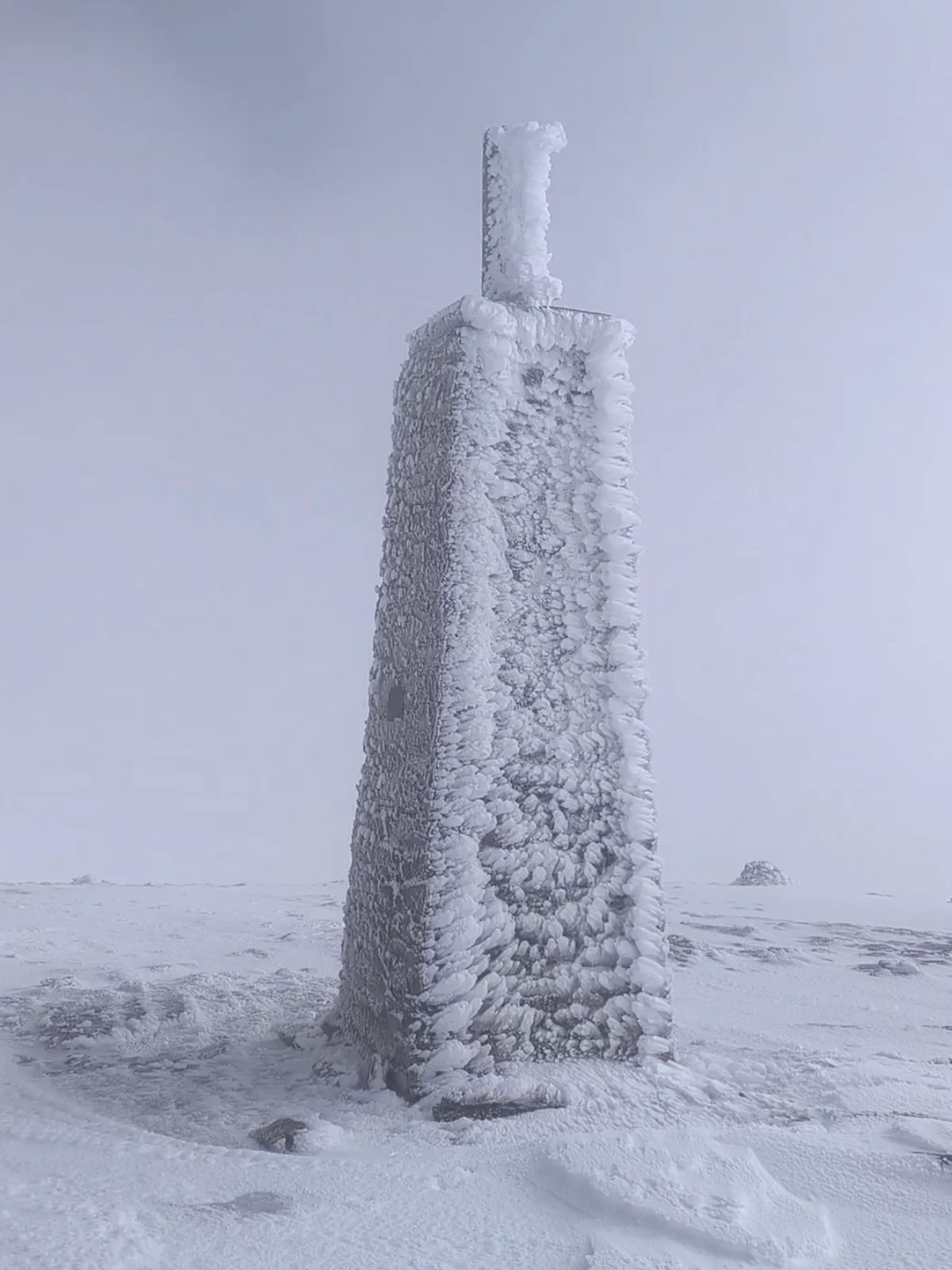 Ice-covered summit cairn on La Maroma