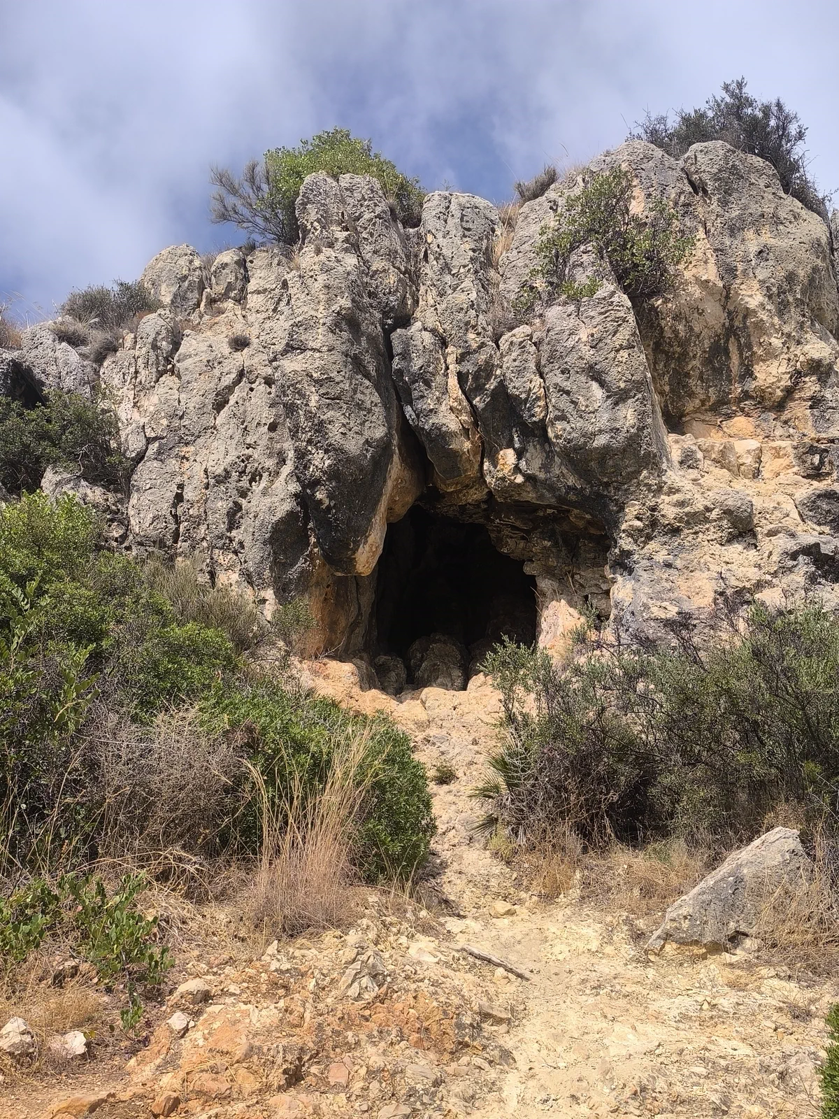 Entrance to a small cave among the rocks of Monte San Antón