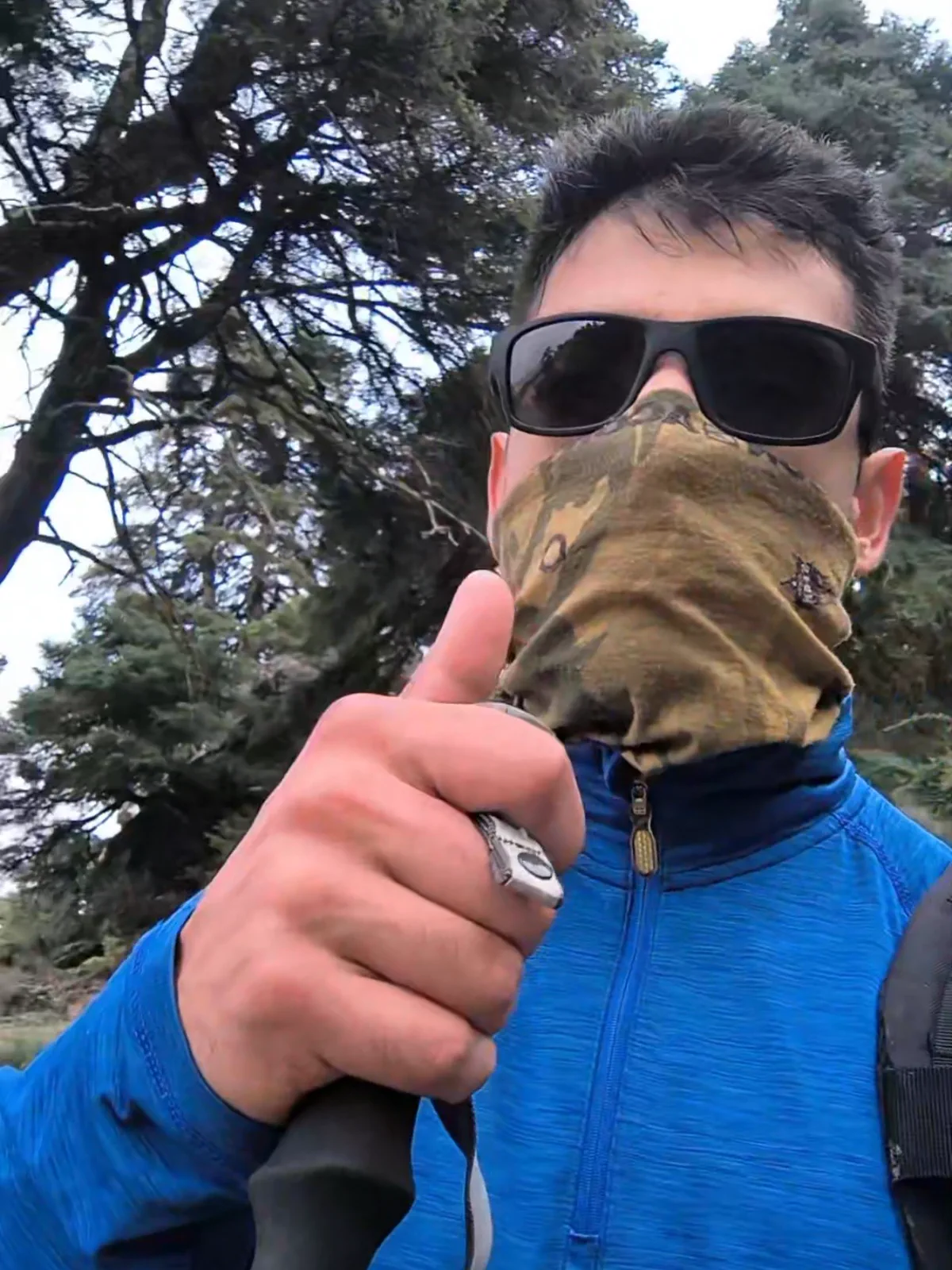 Self-portrait of Bauti wearing mountain clothing in the forest