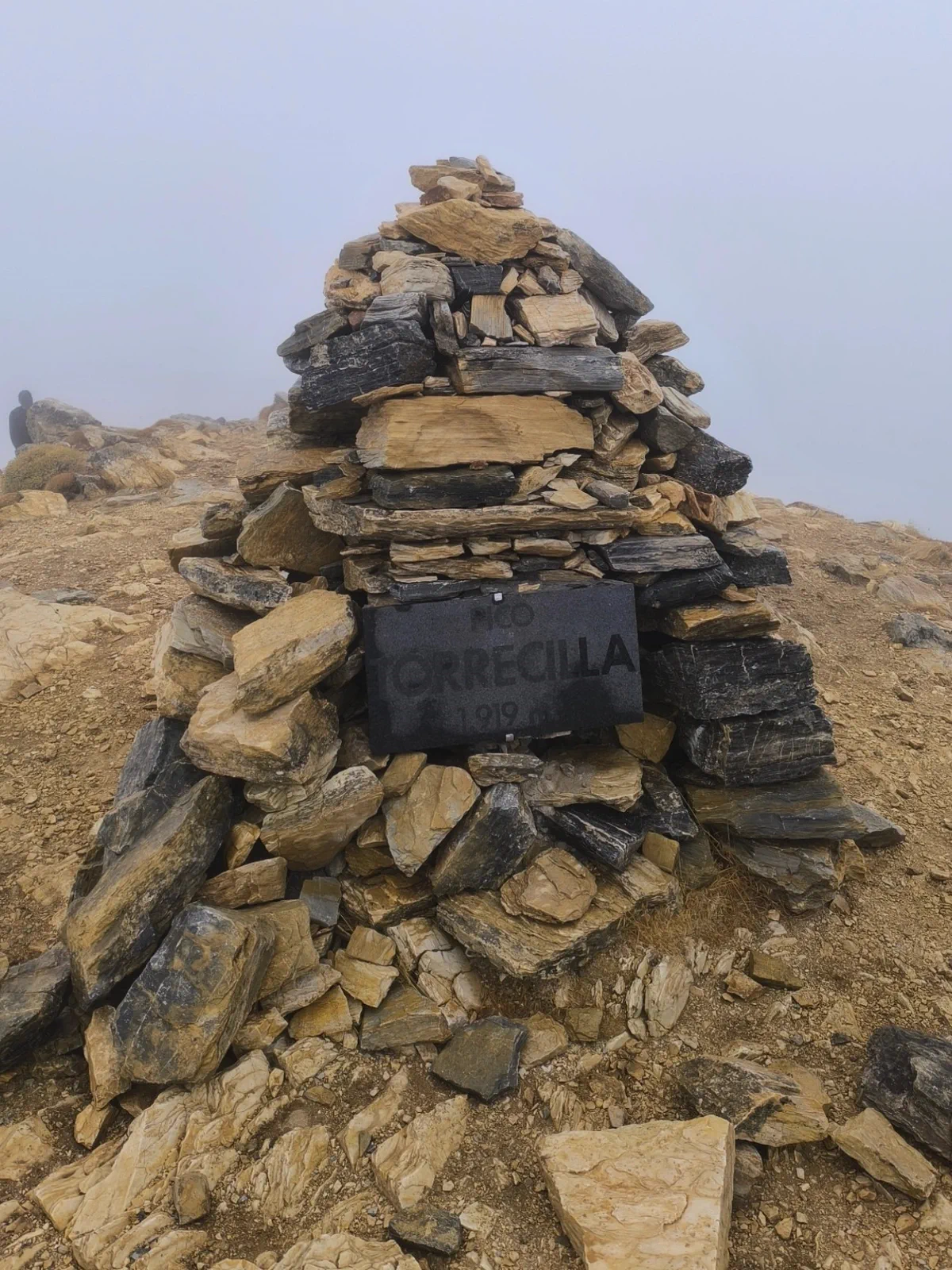 Stone cairn on Pico Torrecilla surrounded by fog