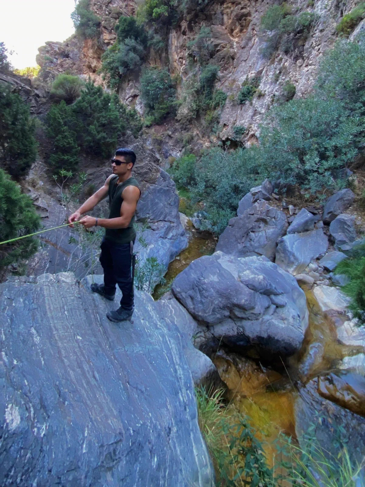 Hiker moving among rocks in the Almanchares river