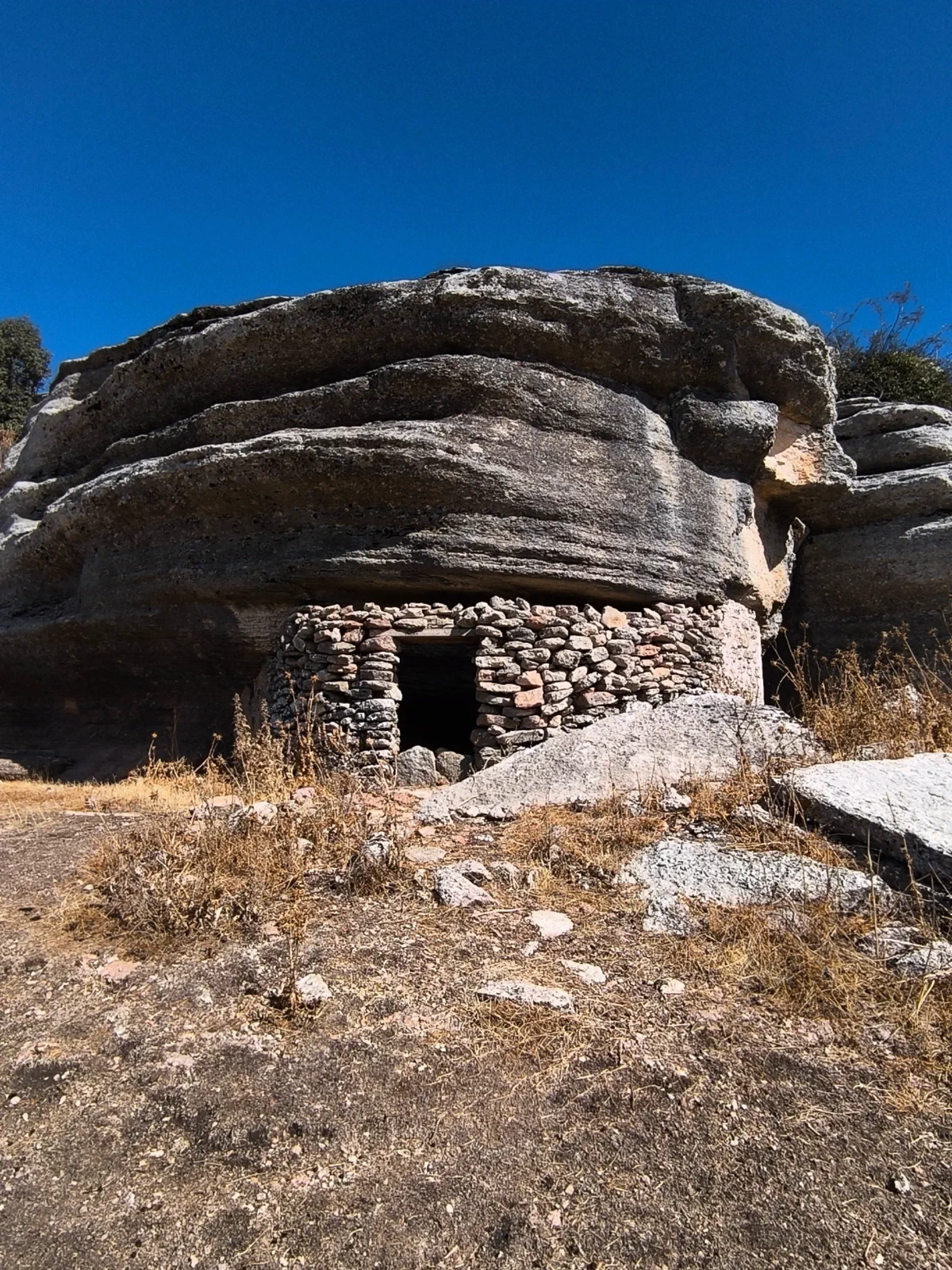 Small shelter built beneath a rock formation